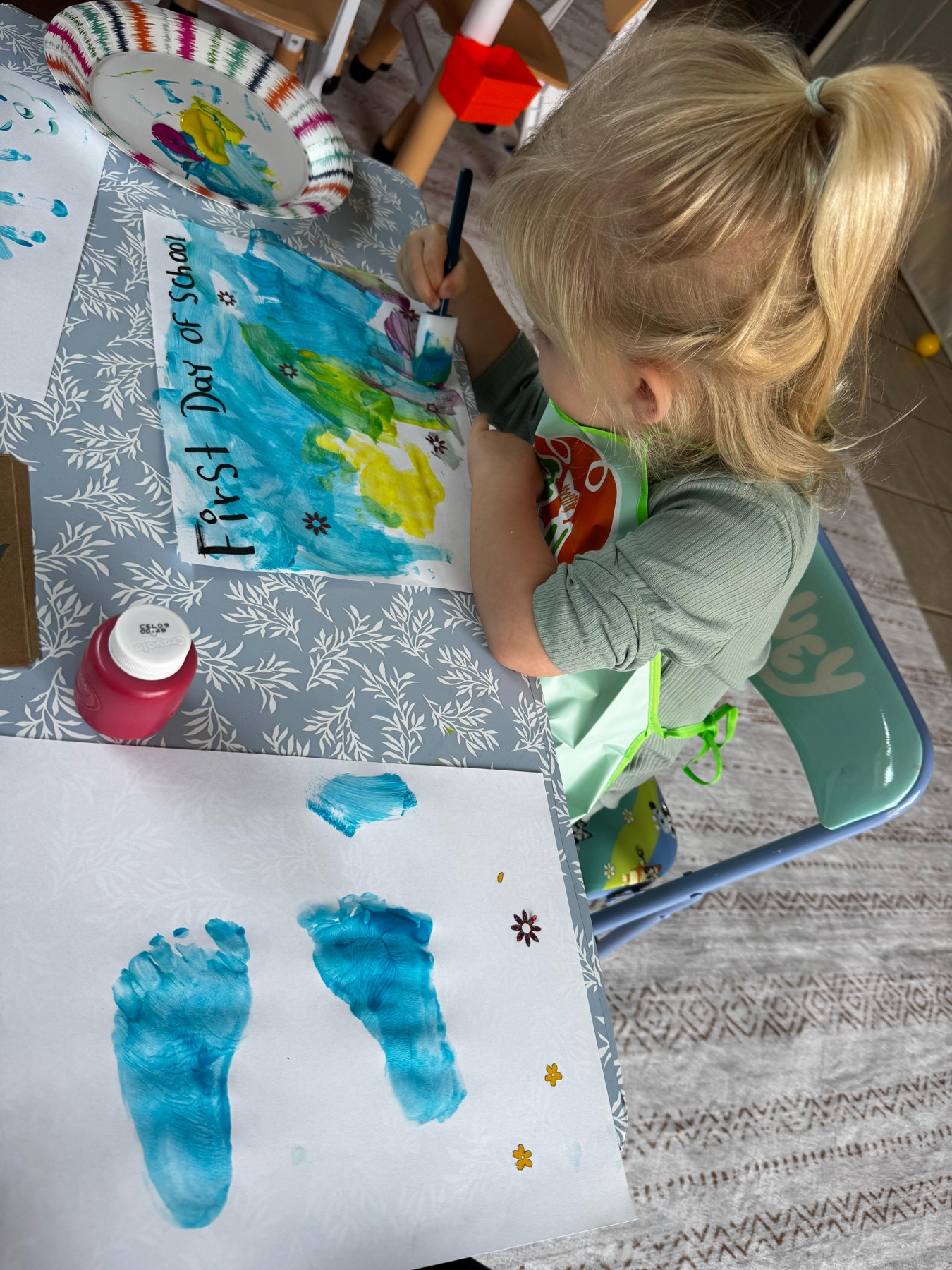 Child painting a first day of school art project at Ale's Home Childcare