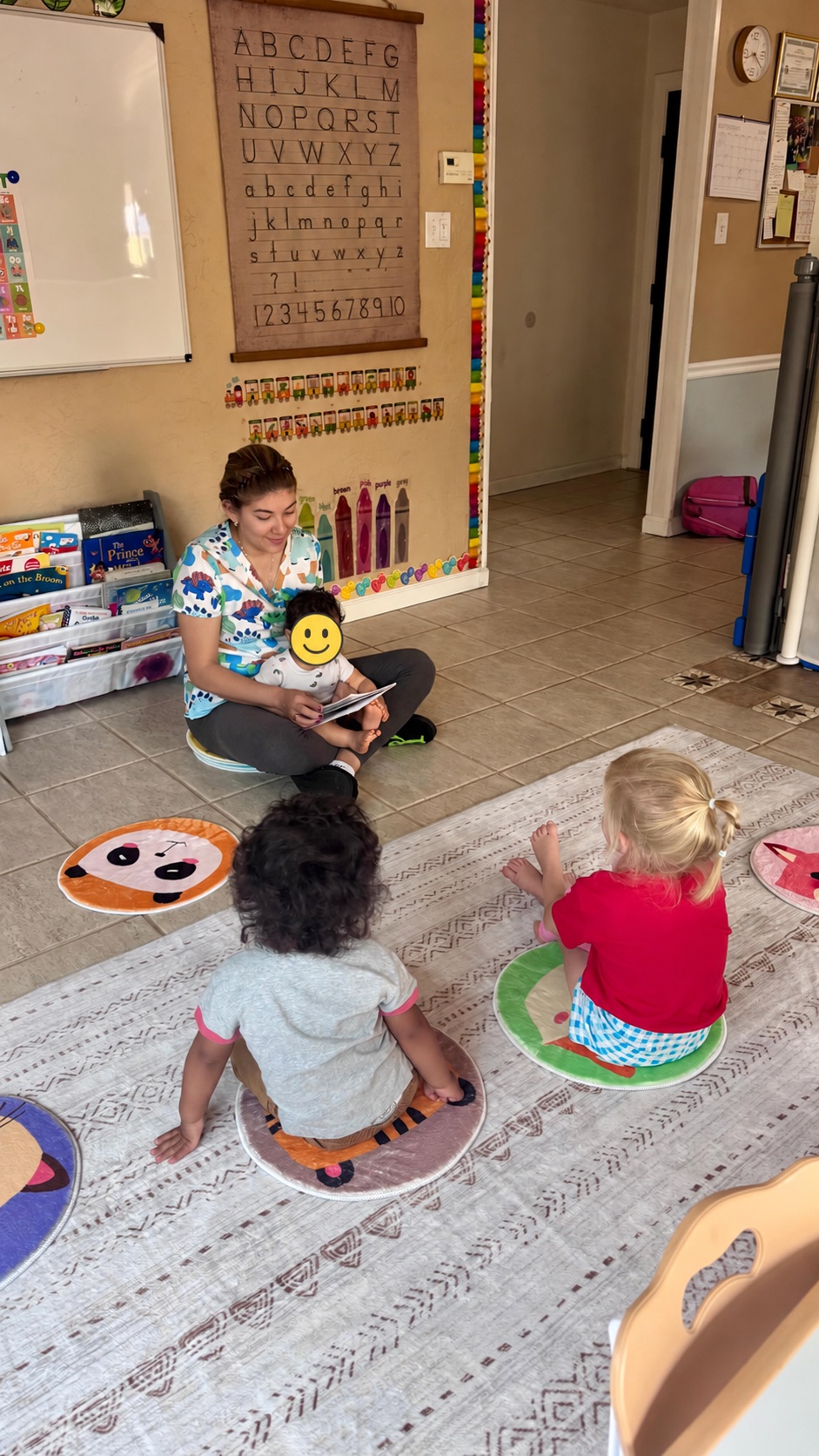 Ale reading with children during story time with visible child face covered for privacy